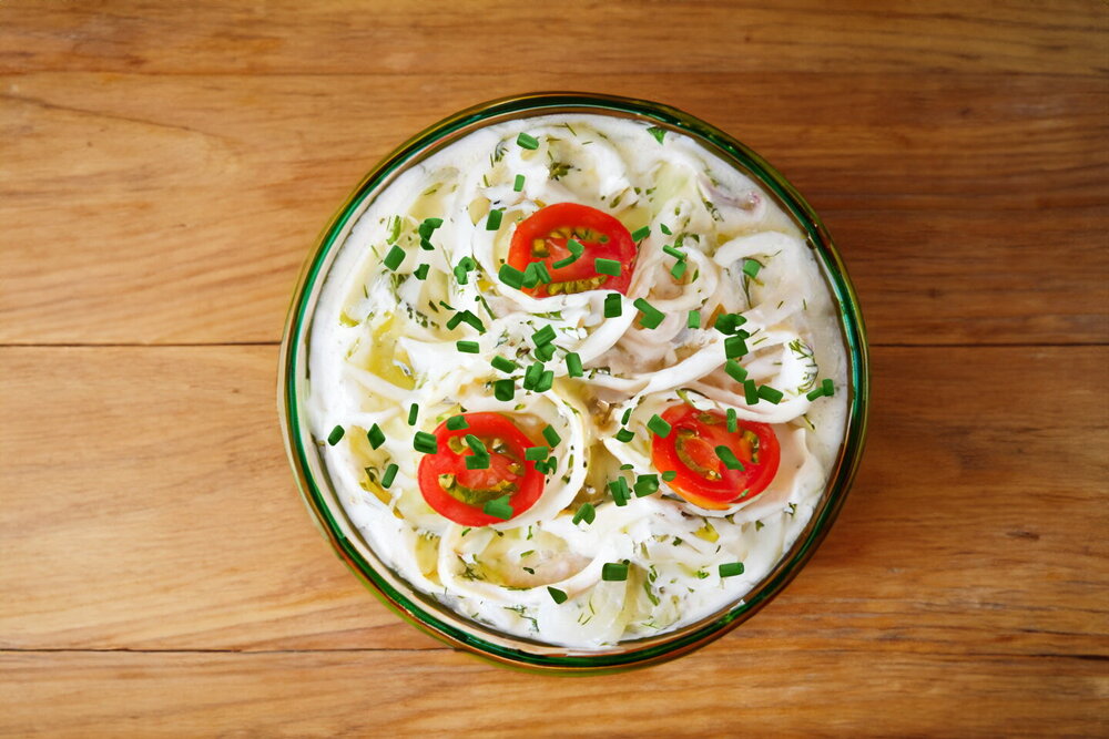 Squid Stewed in Sour Cream with Onions in a Skillet