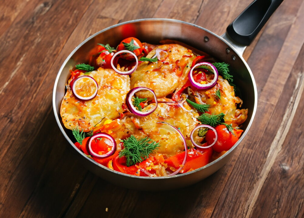 Fried Chicken Fillet with Onions in a Skillet