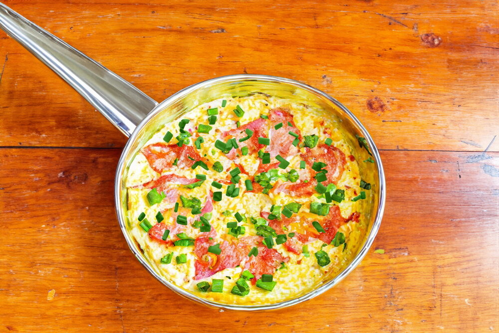 Omelet with Tomatoes and Cheese in a Frying Pan