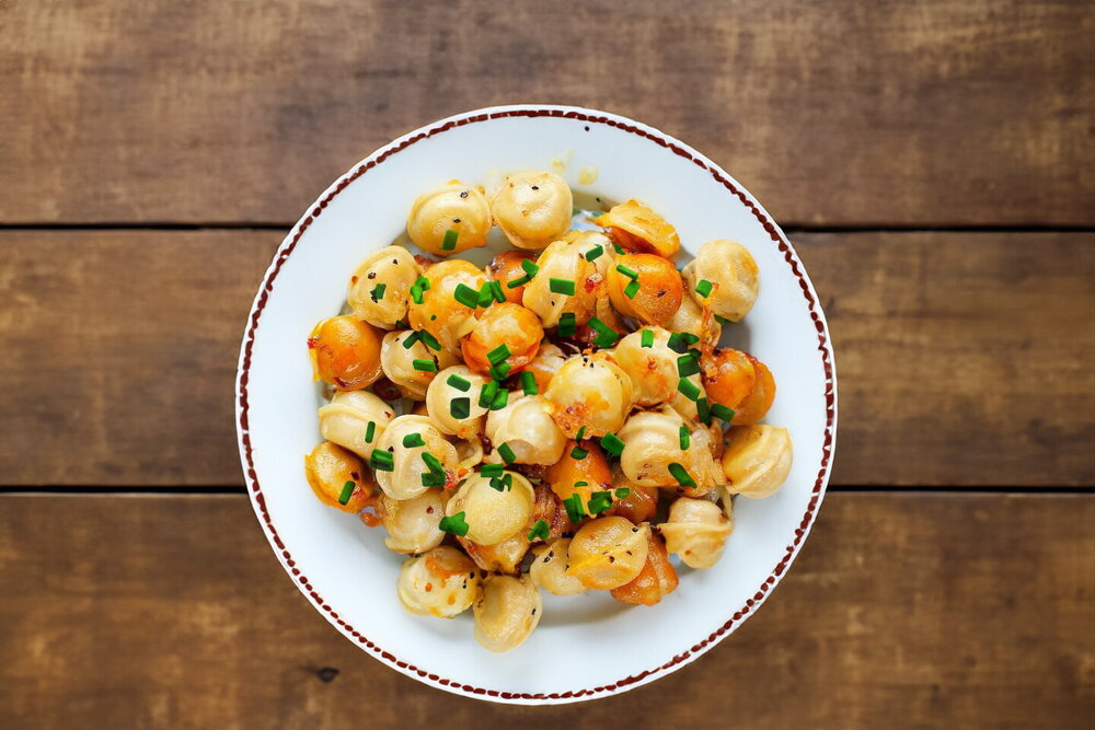 Fried Dumplings with Onion in a Skillet