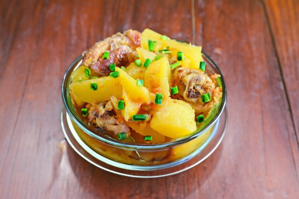 Stewed Potatoes with Chicken in a Skillet