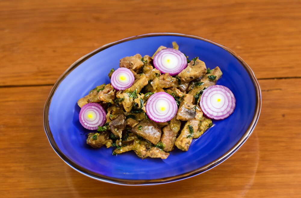 Fried Meat with Mushrooms in a Skillet