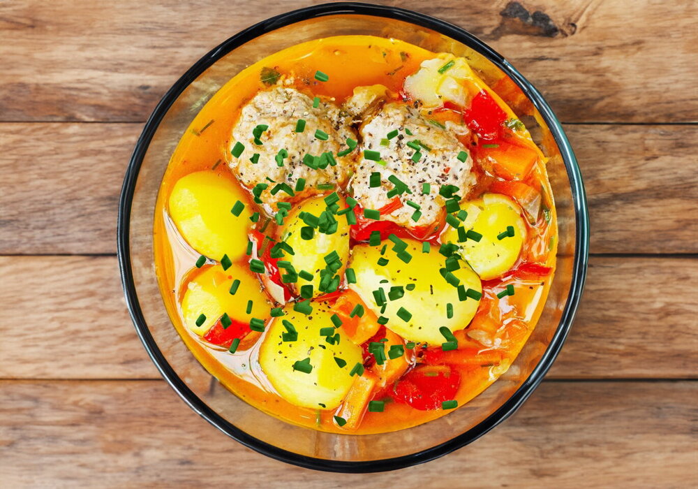 Potato with Meatballs in a Cauldron over a Campfire