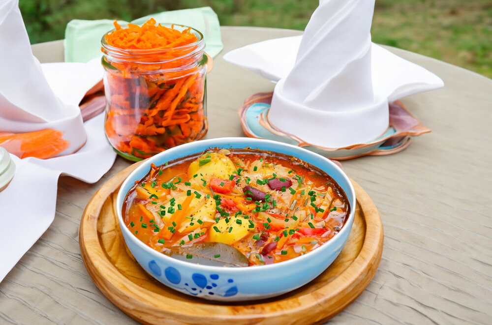 Meatless Borscht with Beans in a Cauldron on an Open Fire