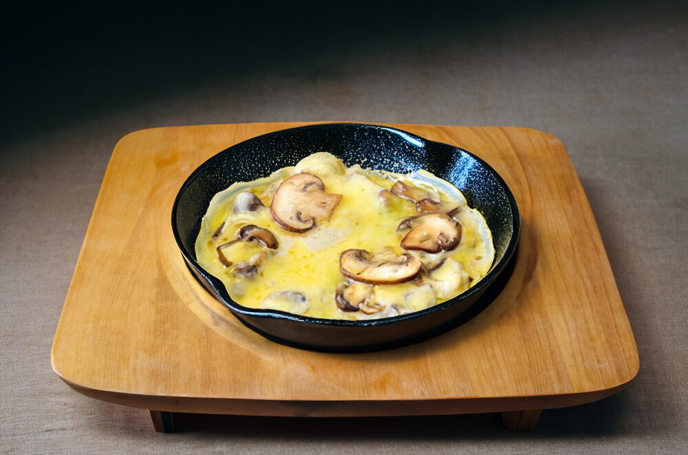 Julienne with Mushrooms and Cheese in a Skillet