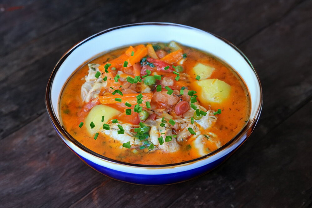 Thick Chicken Soup in a Cauldron over Fire