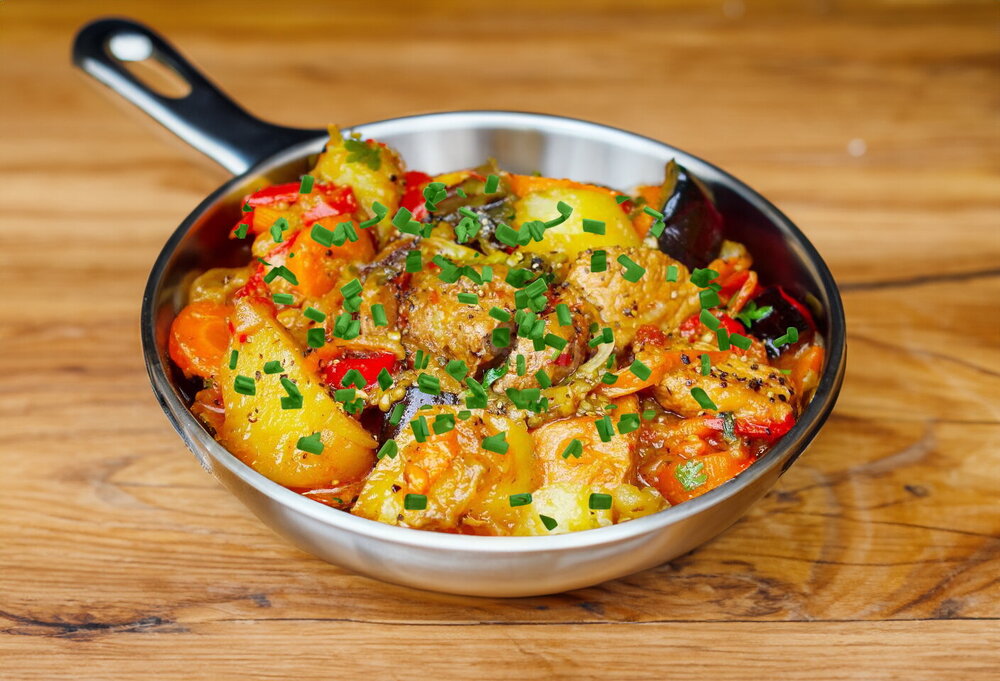 Vegetable Stew in a Cauldron with Meat and Potatoes over a Campfire