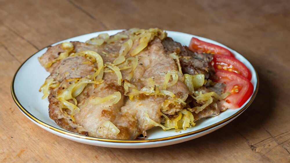 Pork Chops with Onion on a Skillet