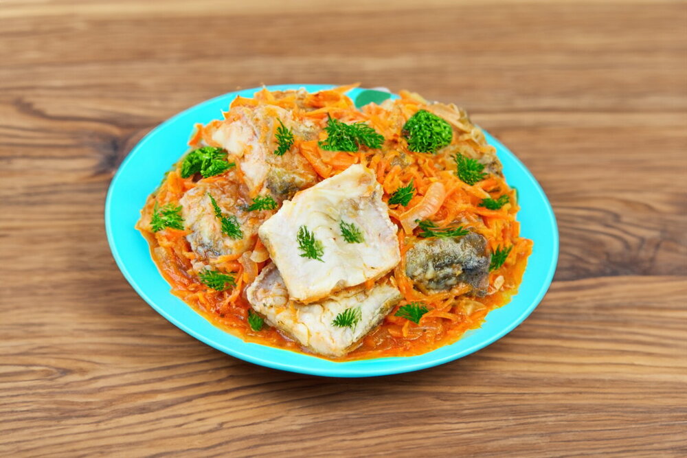 Pollock with Carrots and Onions in a Skillet