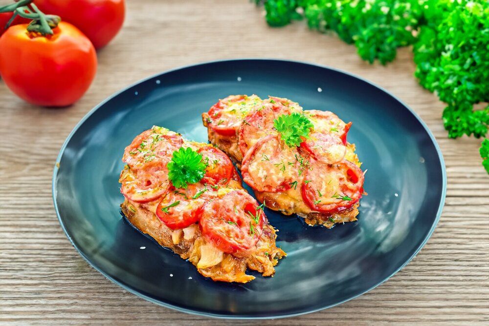 Meat with Tomatoes and Cheese in a Skillet