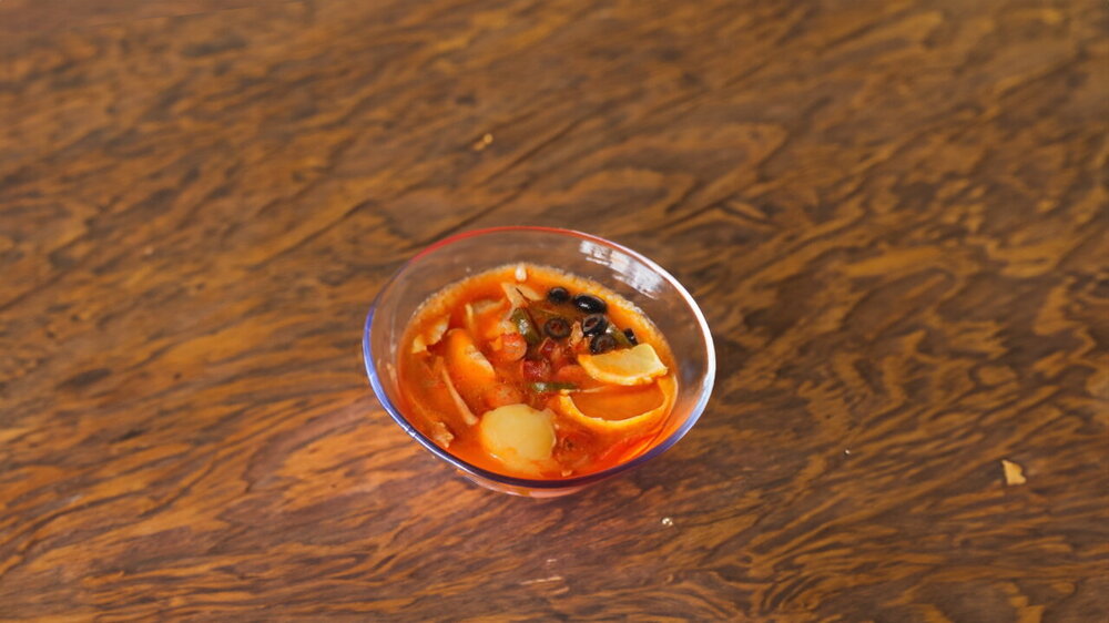 Mixed Meat Solyanka Cooked in a Cast-Iron Pot over Coals