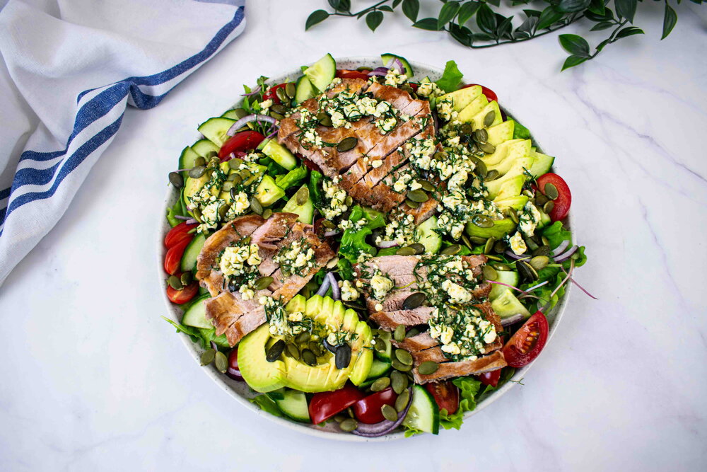 Pork steak salad with blue cheese sauce