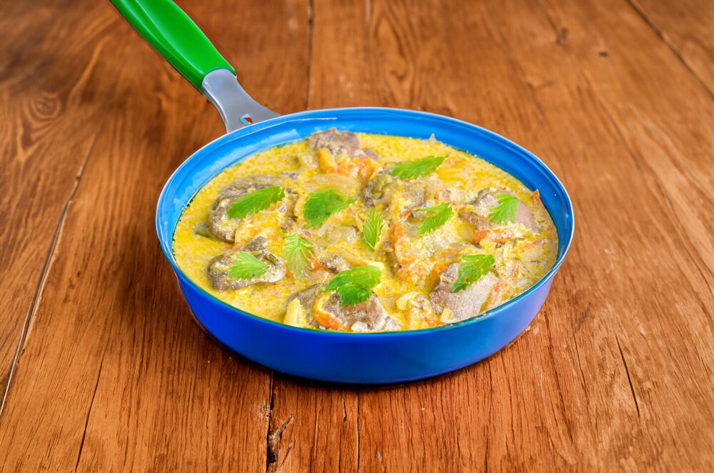 Chicken Liver Braised with Onions and Carrots in Sour Cream in a Skillet